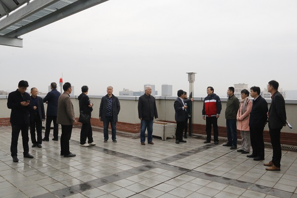 驗(yàn)收委員會專家察看建筑屋面.JPG
